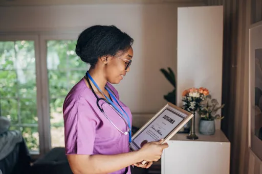 a girl holding a fake nursing diploma